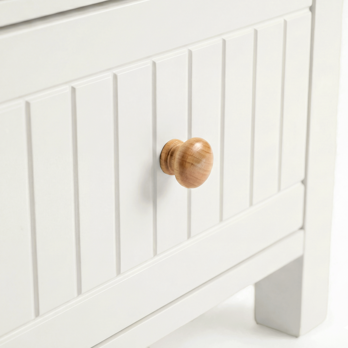 [White] Linra 2-drawer bedside table close-up showing drawer handle and beaded panel front detail