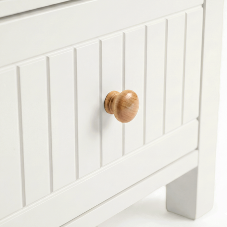[White] Linra 2-drawer bedside table close-up showing drawer handle and beaded panel front detail