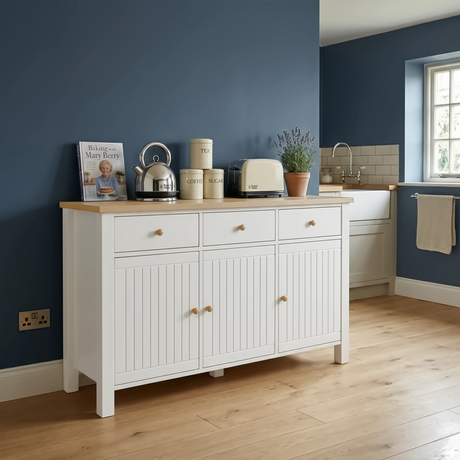 [White] Linra 135cm sideboard front view in a styled room with dark wall and decorative accessories on oak top