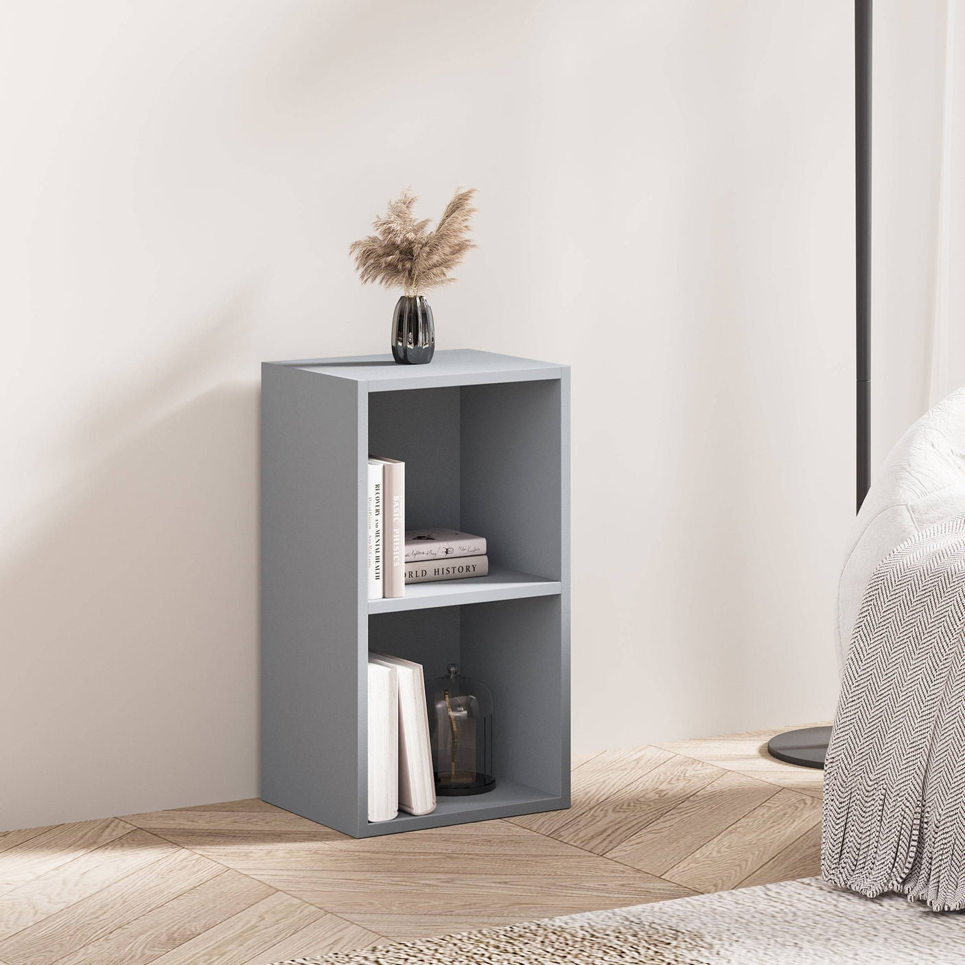 Grey Blisswood small bookcase used as a nightstand with books and decor in a cozy bedroom.