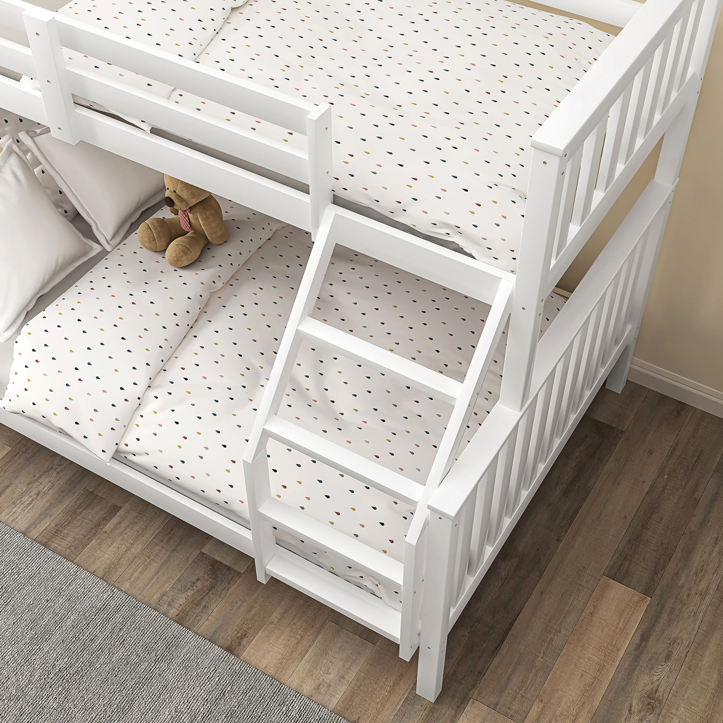 Overhead view of white triple bunk bed for kids with angled ladder and polka dot bedding, perfect for shared bedrooms.