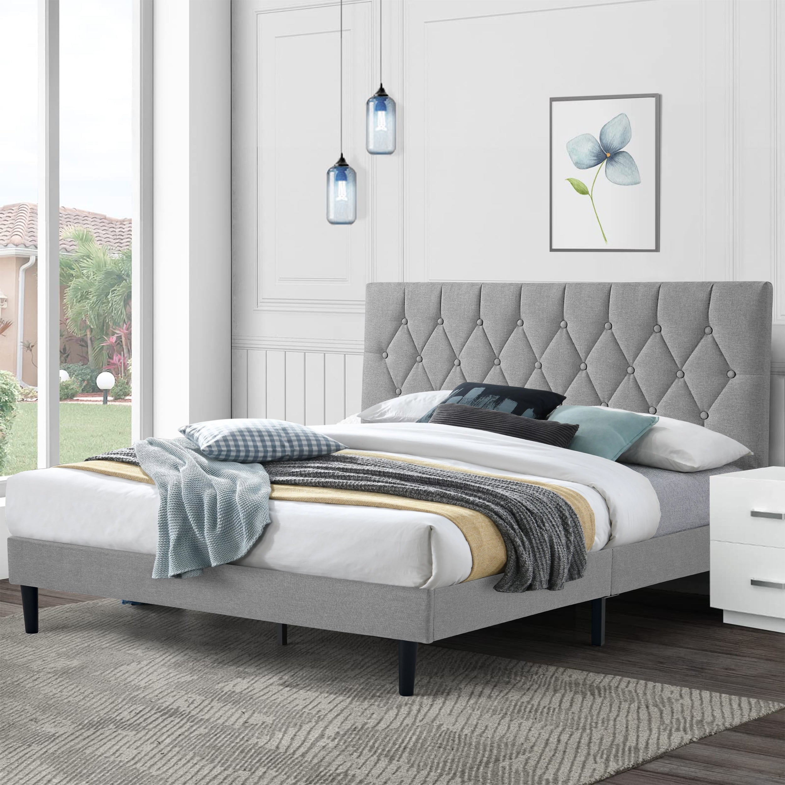 Luxury bed frame with tufted headboard in a stylish modern bedroom.