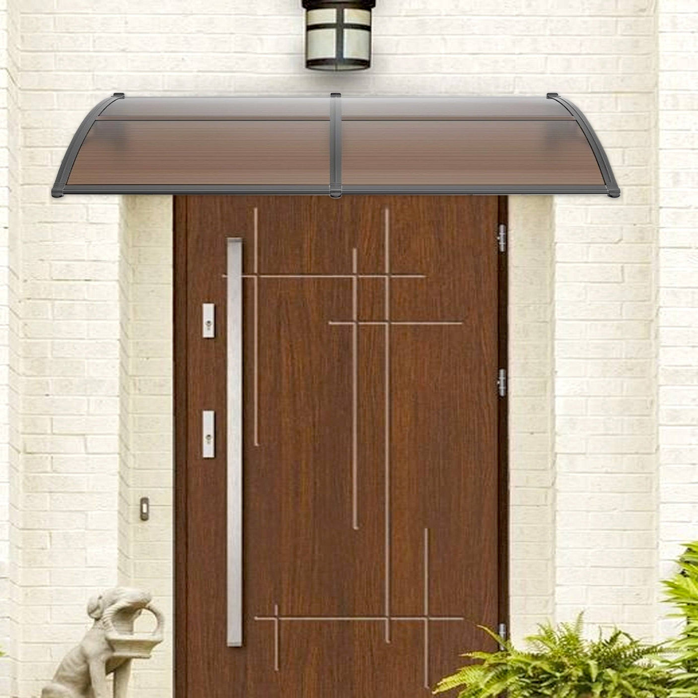 Modern main door canopy with brown polycarbonate sheet and black frame for rain protection.