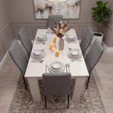 Spacious white dining table and 6 grey PU leather chairs set in a neutral-toned room, ideal for stylish kitchen or dining areas.