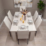 Elegant white dining table set for 6 with PU leather chairs and candles. A modern centerpiece for dining rooms or kitchen areas.