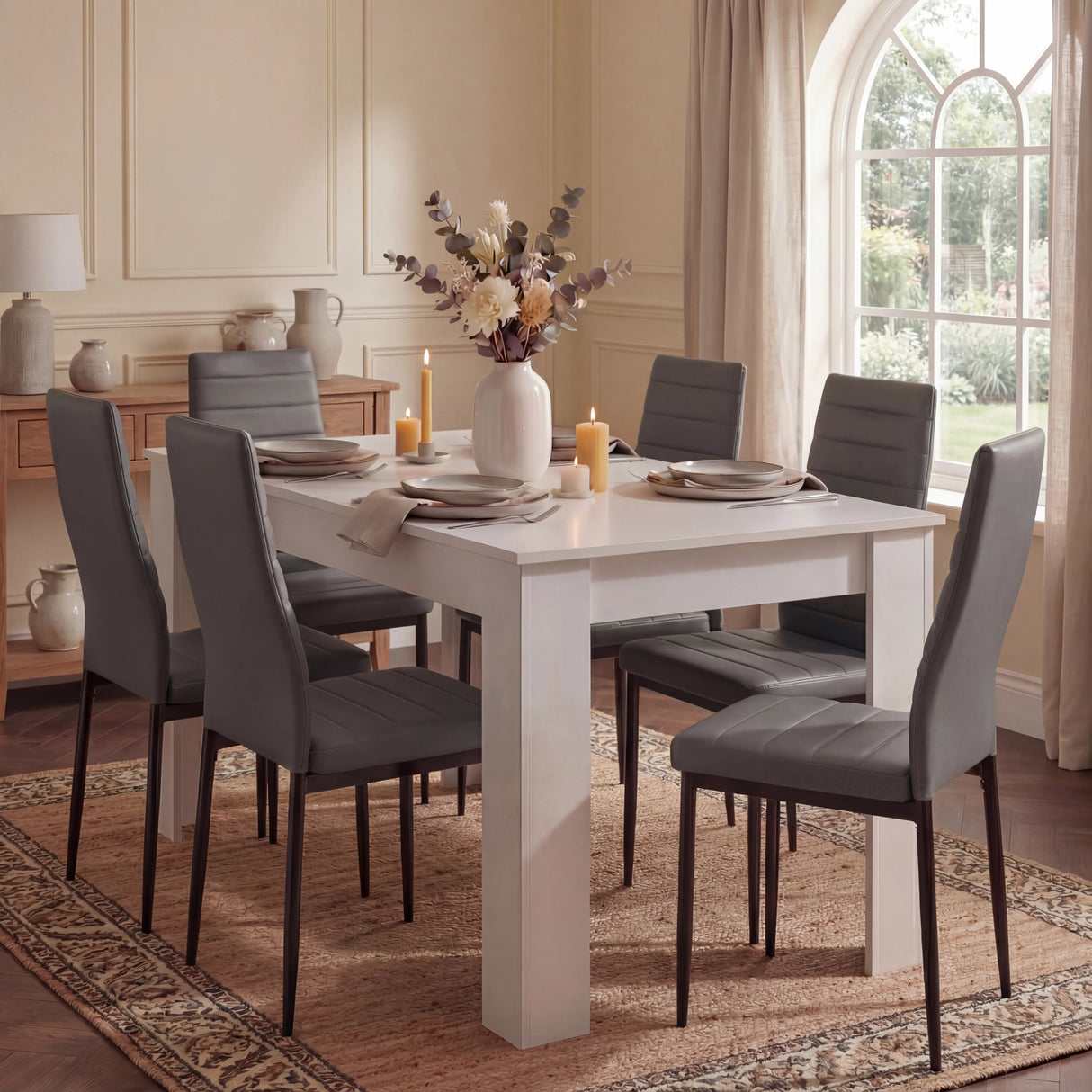 Elegant white dining table set with 6 grey PU leather chairs in a classic dining room, perfect for family dinners or entertaining guests.