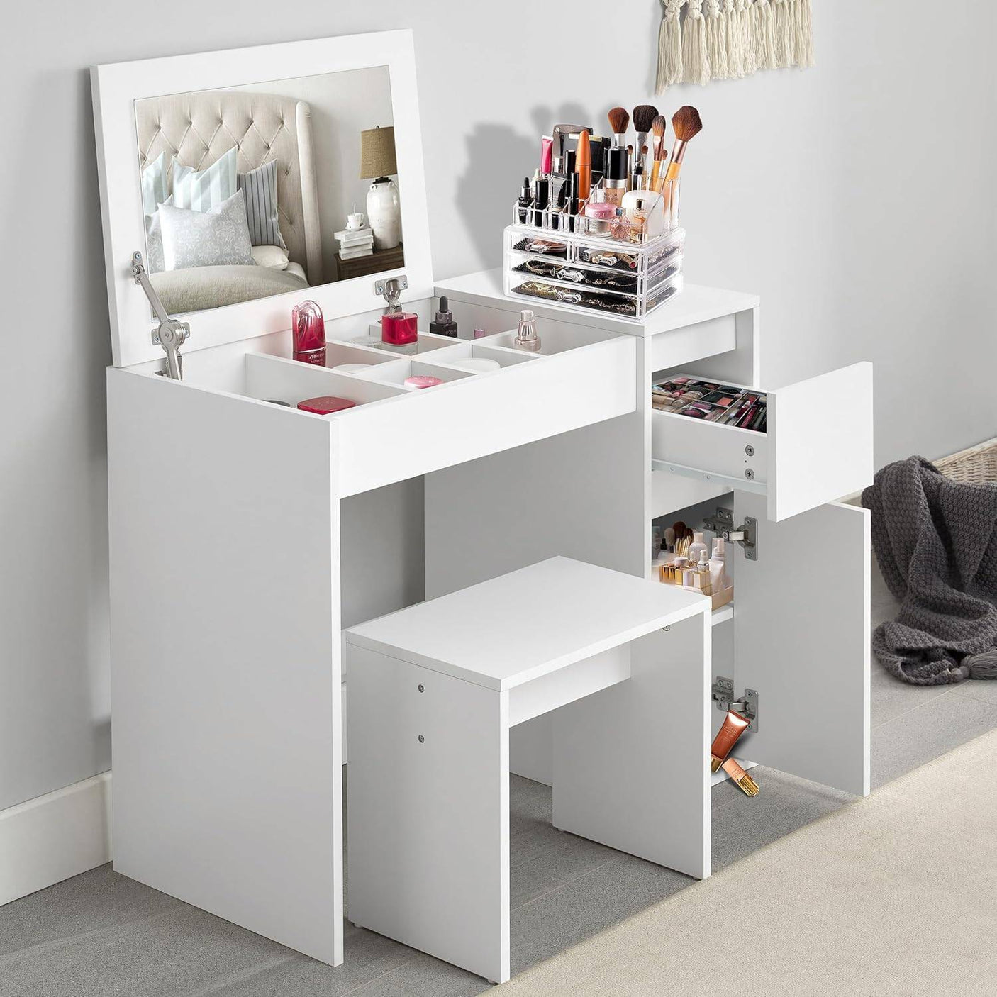 Small dressing table with flip-up mirror and stool in white, featuring multiple storage compartments and drawers for makeup and beauty accessories.