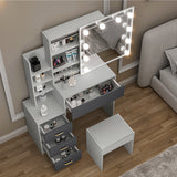 Makeup light for dressing table, grey drawers, shelves, and stool for organized storage.