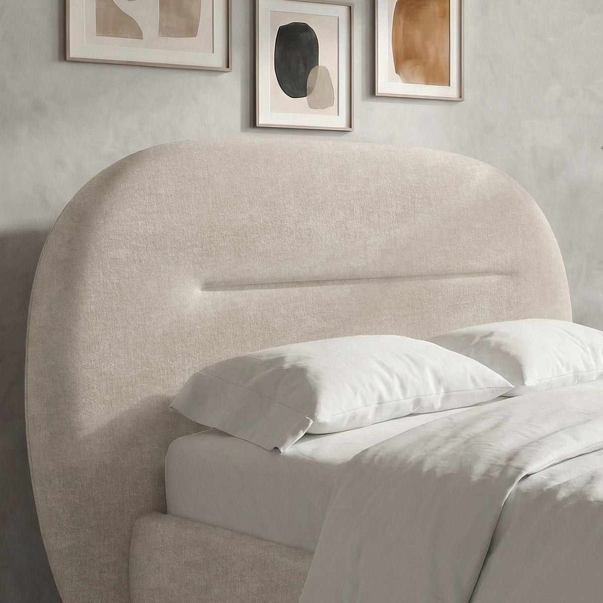 [King | Beige] Close-up detail of the padded headboard of a beige king upholstered bed frame with light linens