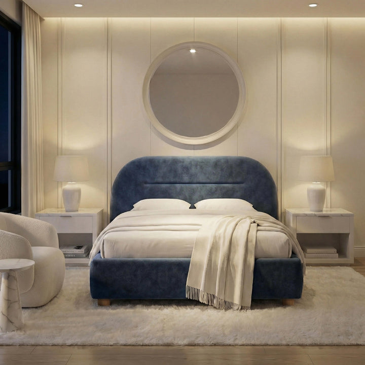 [Blue | King] Moody evening shot of velvet upholstered bed with fringed throw in white bedroom with ambient lamp glow