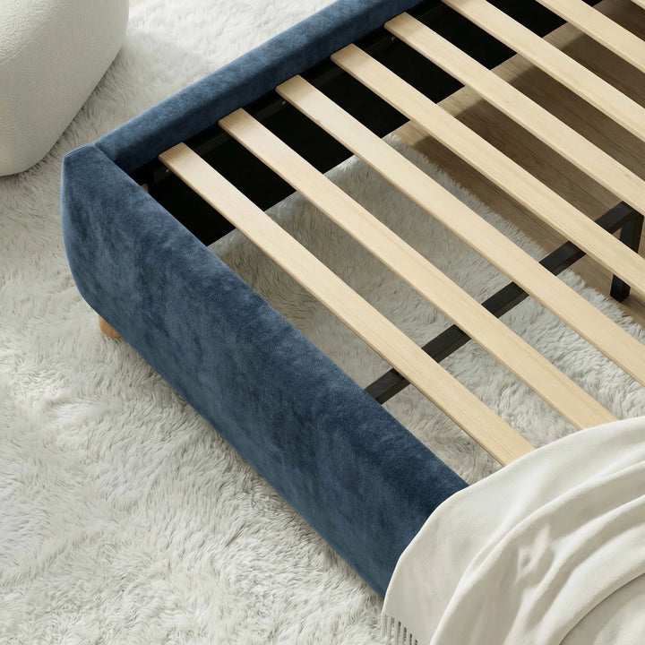 [Blue | King] Close-up of slat system fitted inside velvet frame with boucle pouf and white shag rug visible nearby