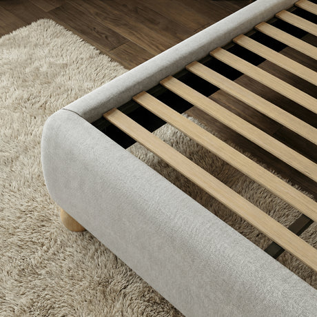 [Grey | Double] Wooden slat base inside upholstered frame showing evenly spaced slats with padded curved rail on shag rug