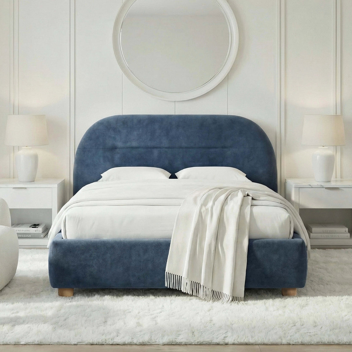 [Blue | King] Arch headboard bed frame dressed with white bedding below large circular mirror on panelled accent wall