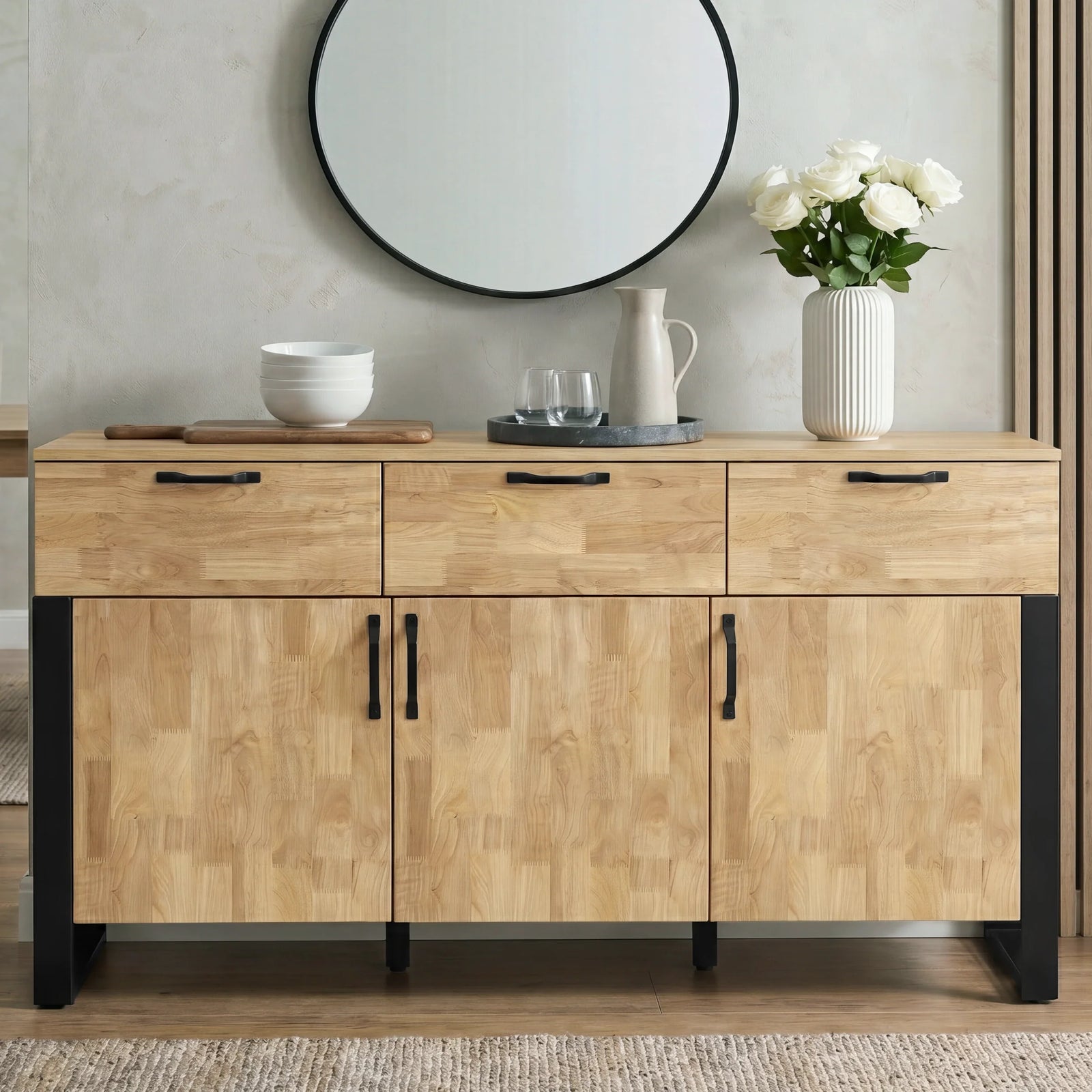 [Mango Wood Effect] Ironmere sideboard front view with closed drawers and doors, round mirror, vase, bowls, and wall slats.