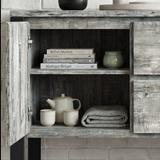 [Grey] Millwright sideboard open cabinet view with shelves, books, ceramics, and folded table cloth inside