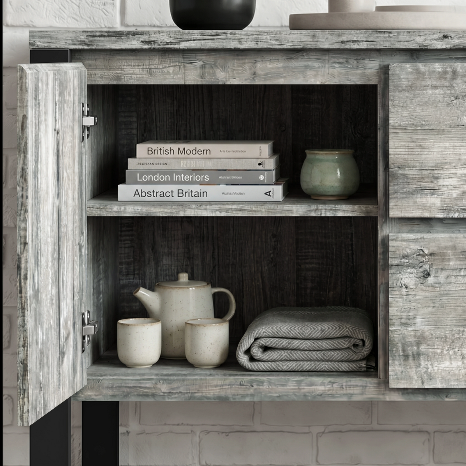 [Grey] Millwright sideboard open cabinet view with shelves, books, ceramics, and folded table cloth inside