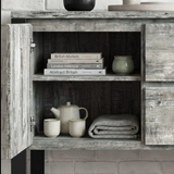 [Grey] Millwright sideboard open cabinet view with shelves, books, ceramics, and folded table cloth inside