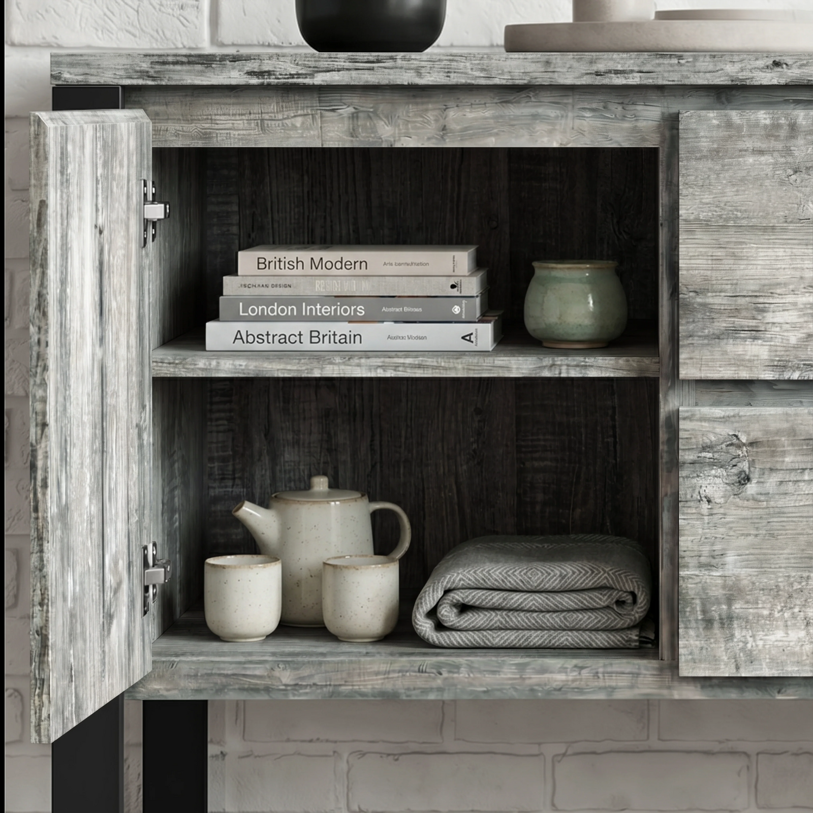 [Grey] Millwright sideboard open cabinet view with shelves, books, ceramics, and folded table cloth inside