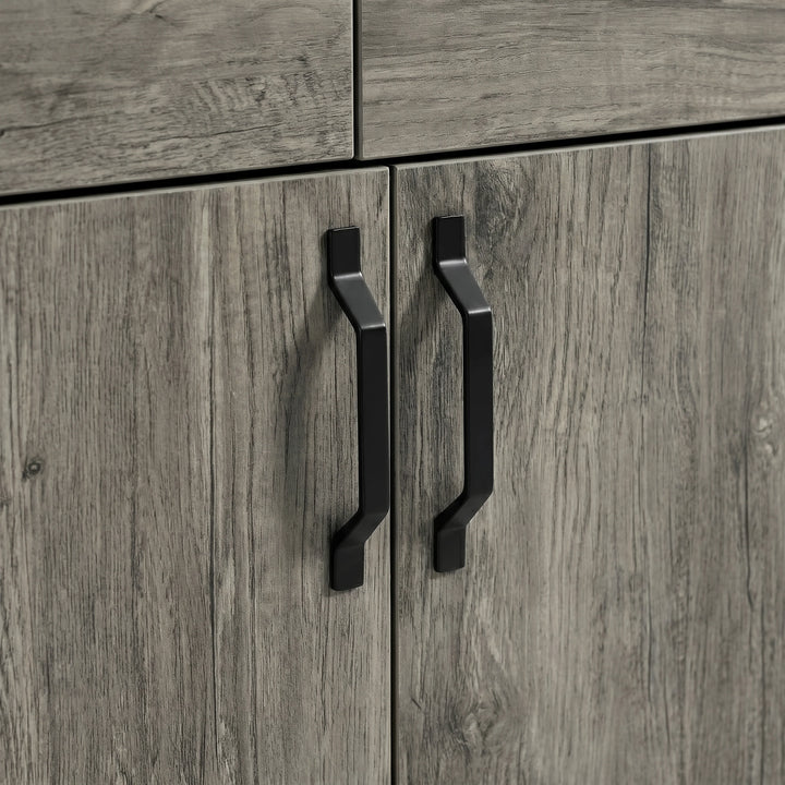 [Wooden Grey] Millwright sideboard close-up showing black angular handles on wooden grey doors