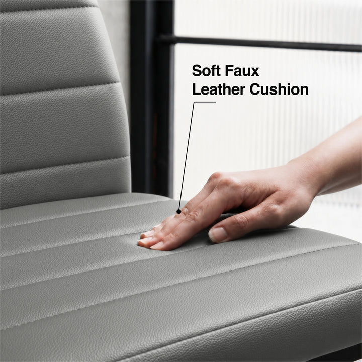[6 Seater | Grey] Close-up of the Milo faux leather chair cushion pressed by a hand