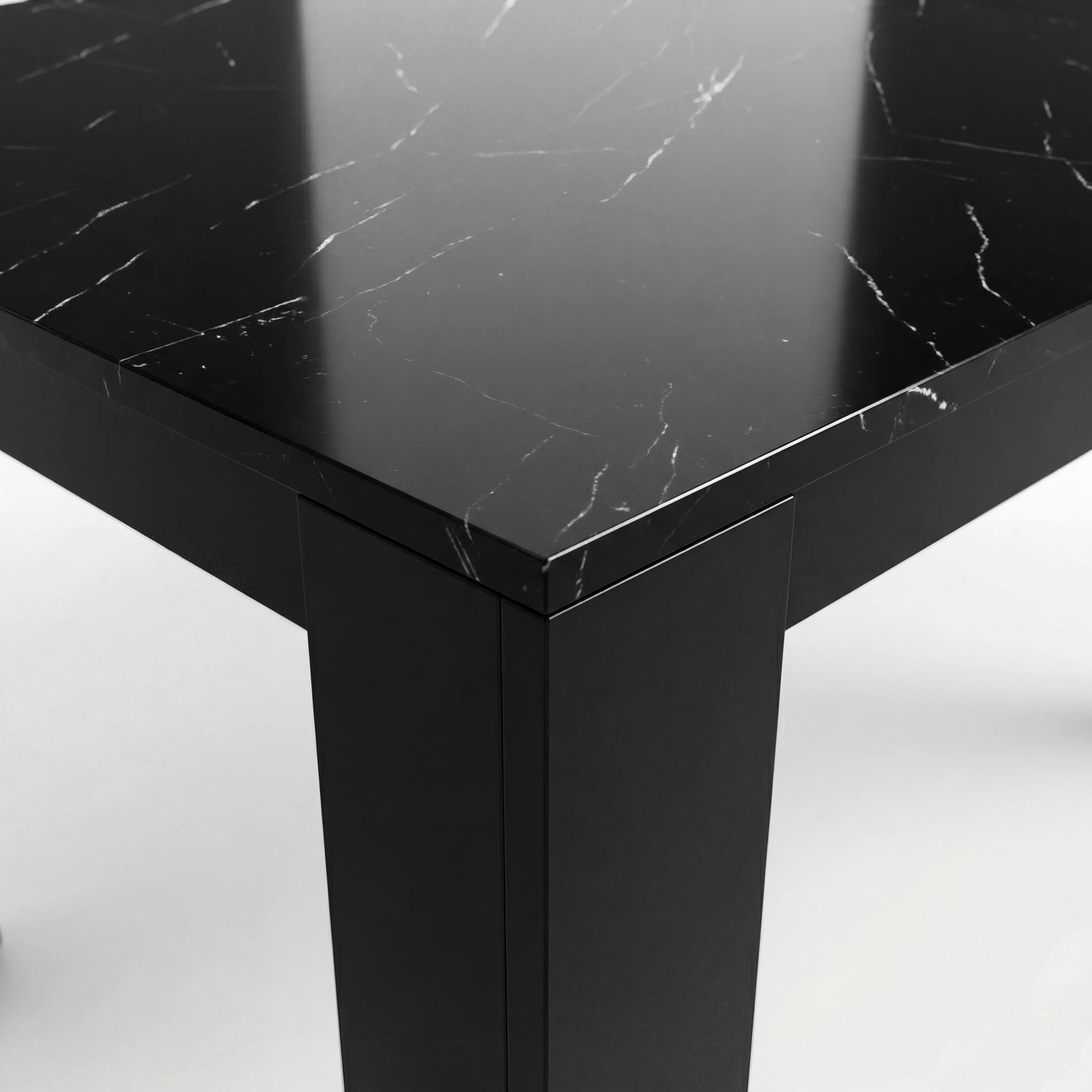 [8 Seater | Black] Close-up of the Milo black marble-effect tabletop edge, surface texture, and inverted-L shaped leg