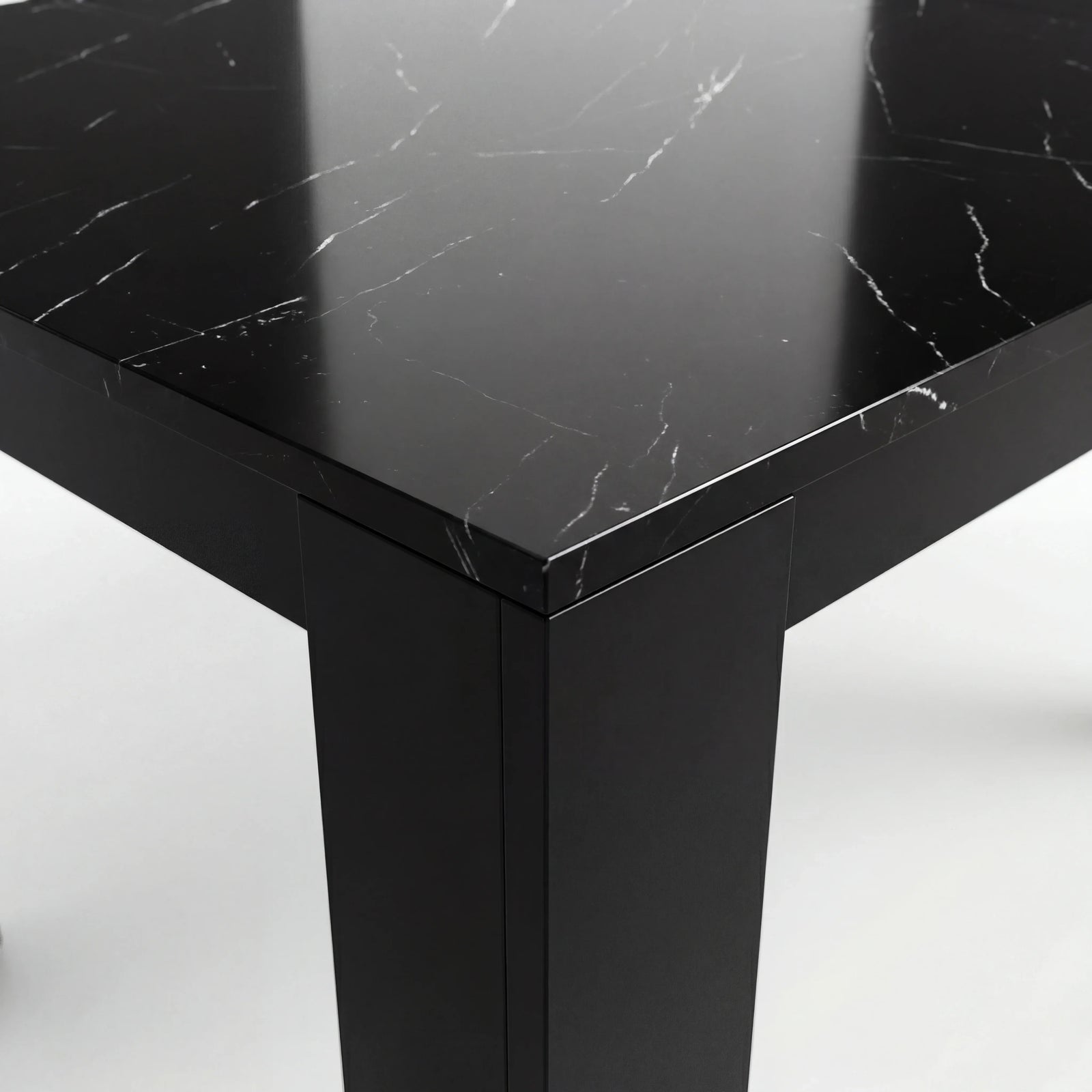 [8 Seater | Black] Close-up of the Milo black marble-effect tabletop edge, surface texture, and inverted-L shaped leg