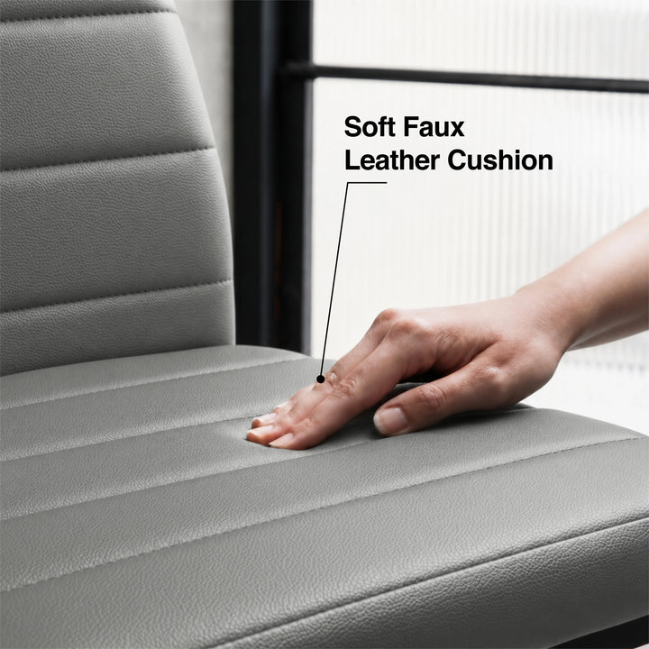 [8 Seater | Grey] Close-up of the Milo faux leather chair cushion pressed by a hand