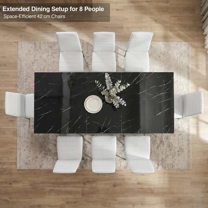 [8 Seater | White] Overhead view of the Milo black marble-effect extended dining table layout with space-efficient chairs