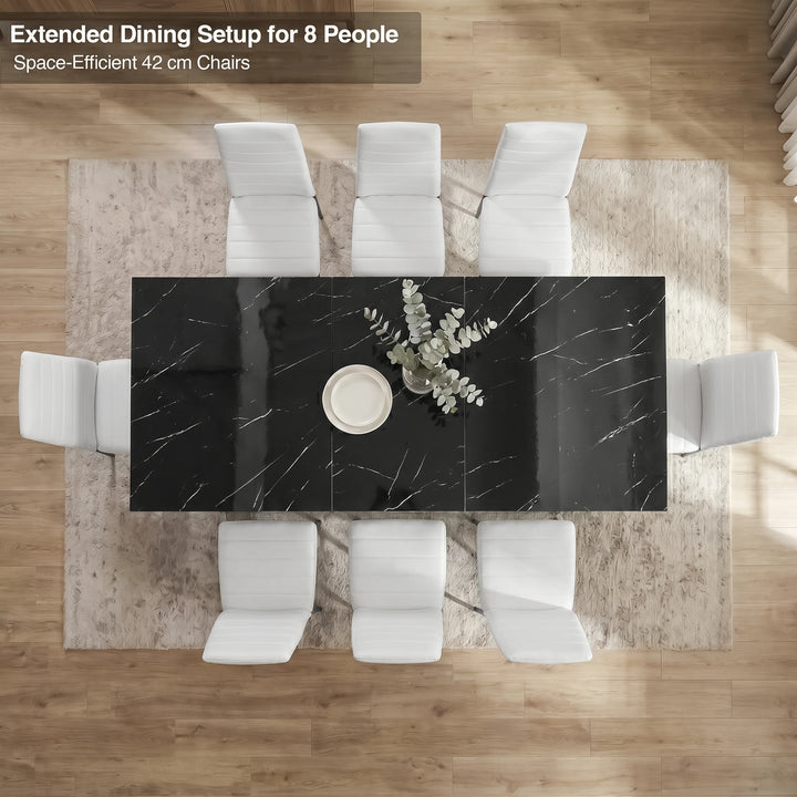[8 Seater | White] Overhead view of the Milo black marble-effect extended dining table layout with space-efficient chairs