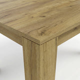[8 Seater | White] Close-up of the Milo oak-effect tabletop corner, wood grain, and inverted L-shaped table leg