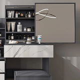 Grey vanity table with large mirror and marble drawer. Features open shelving and ample storage for beauty products in a modern bedroom setup.