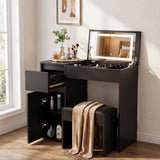 [Black] vanity table with built-in mirror, illuminated LED lighting, drawers, open storage cabinet, and matching stool in a bright room.