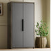 Gray wardrobe with wooden base and plant in a pot against a beige wall.