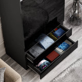 two bottom drawers of black high gloss wardrobe pulled out showcasing folded clothes in vibrant colours