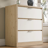 Skova chest of drawers, a three-drawer unit in white and wooden finish, placed against a wall in natural light near a window