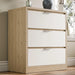 Skova chest of drawers, a three-drawer unit in white and wooden finish, placed against a wall in natural light near a window