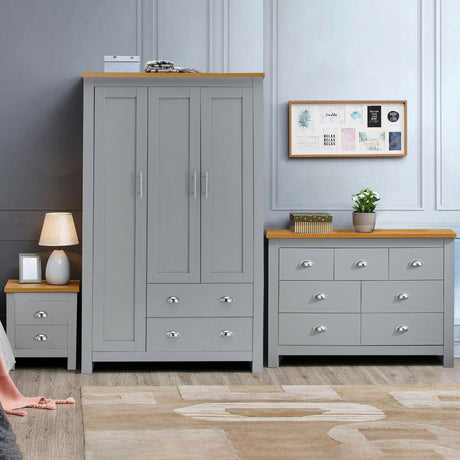 Modern grey 3-piece bedroom furniture set with a wardrobe, dresser, and bedside table.