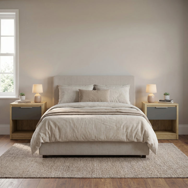 [Oak+Grey] Oak bedside table with grey drawer next to bed flanked by linen pillow and styled accessories