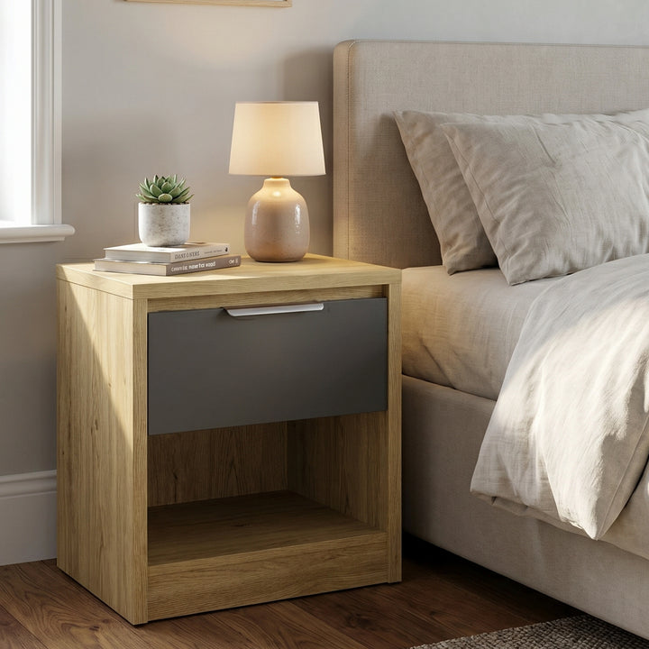 [Oak+Grey] Oak bedside table with grey drawer and open shelf styled beside upholstered bed with lamp and plant