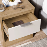 [Oak+White] Oak bedside table with white drawer and open shelf holding books, styled with table lamp beside a bed