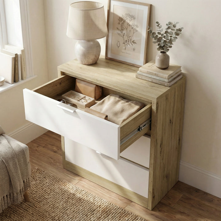 [Oak+White] Top drawer of Skova chest of drawers open from above showing folded textile and small box inside