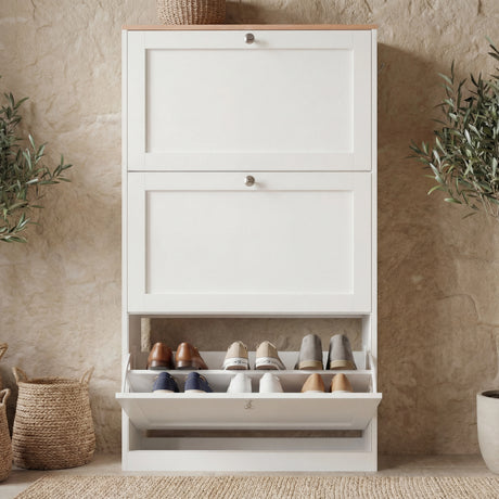 White modern shoe storage unit closed, compact design suited for narrow entry spaces with one drawer opened view