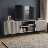 Modern grey TV unit with vertical fluted doors and open shelving, providing a sleek storage solution for contemporary homes.