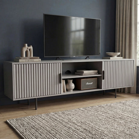 Modern grey TV unit with vertical fluted doors and open shelving, providing a sleek storage solution for contemporary homes.
