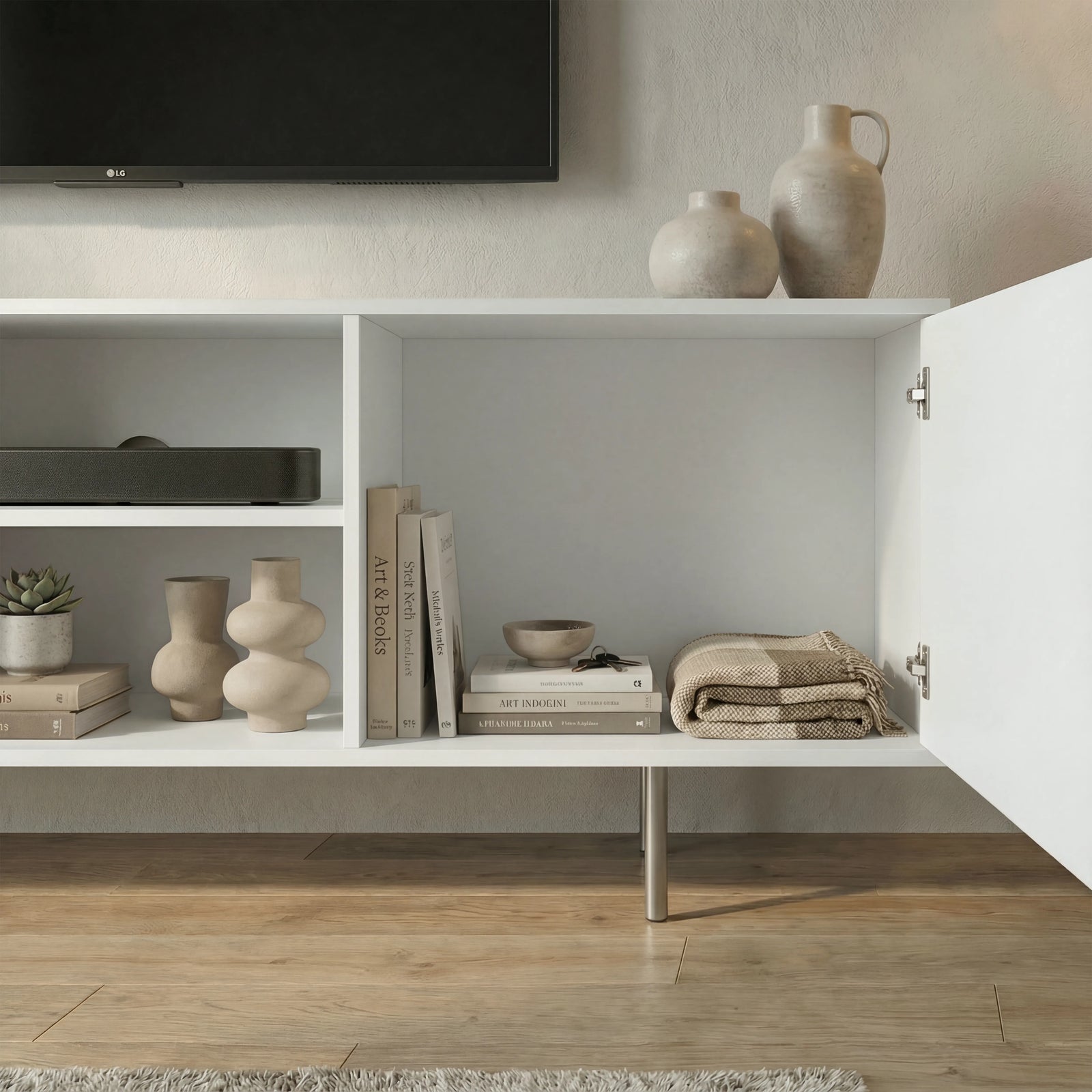 [White]  White 140cm TV cabinet showing inside storage, books and stoneware vases on shelves with both ribbed doors swung open