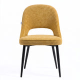 [Mustard | Set of 4] Front view of comfy fabric dining chair with rounded open back, piped seat and four black metal legs.