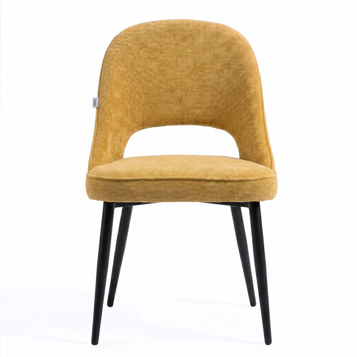 [Mustard | Set of 4] Front view of comfy fabric dining chair with rounded open back, piped seat and four black metal legs.
