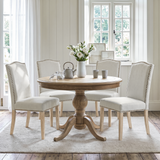 [Beige | Set of 4] Four nailhead dining chairs shown around a round wooden dining table in a dining room