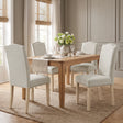 [Beige | Set of 4] Nailhead Dining Chairs set of 4 in beige fabric styled around a wooden dining table.