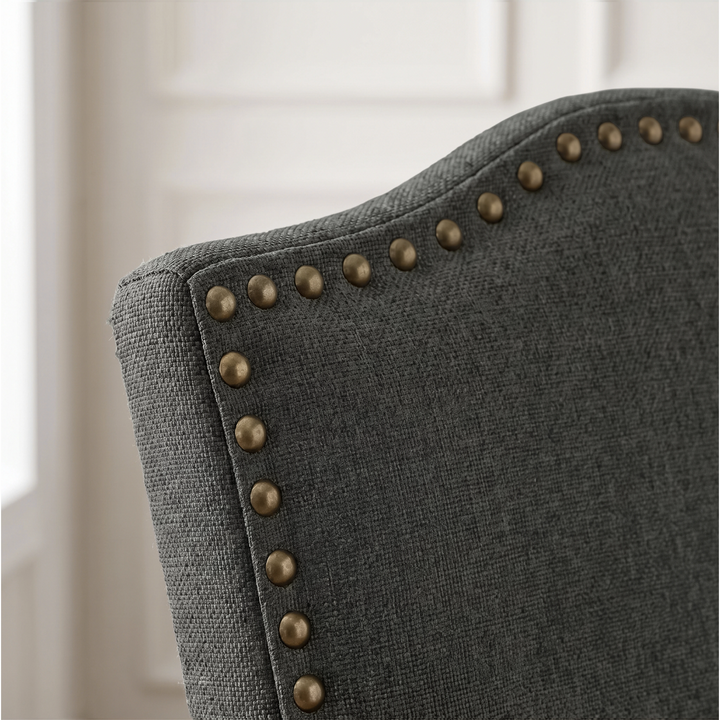 [Dark Grey | Set of 4] Close-up detail of bronze nailhead trim on Dark Grey fabric dining chair back.